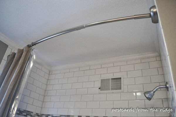 white and beige shower with a curved shower curtain rod... Should You Change Your Shower Rod for Winter? from Bathroom Bliss by Rotator Rod