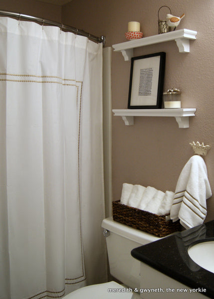 small but lovely beige bathroom with white shower curtain and curved shower rod... Should You Change Your Shower Rod for Winter? from Bathroom Bliss by Rotator Rod