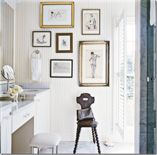 small white bathroom with make up vanity, stool, and gallery wall with figure paintings and drawings... Small Bathroom Chic: Artwork Brightens Bathroom Space from Bathroom Bliss by Rotator Rod