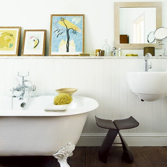 small white bathroom with claw footed tub and artwork on display... Small Bathroom Chic: Artwork Brightens Bathroom Space from Bathroom Bliss by Rotator Rod