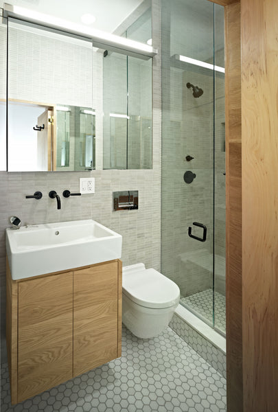 small white bathroom with light wood accents, glass shower doors... Small Bathroom Ideas: Shower Spaces from Bathroom Bliss by Rotator Rod