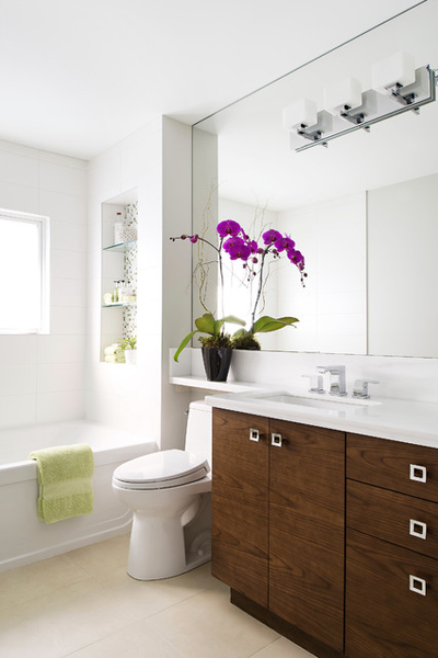 white bathroom with wood accents, purple orchid flowers, and oversized mirror... Small Bathroom Ideas: Trendy Bathroom Mirror Updates from Bathroom Bliss by Rotator Rod