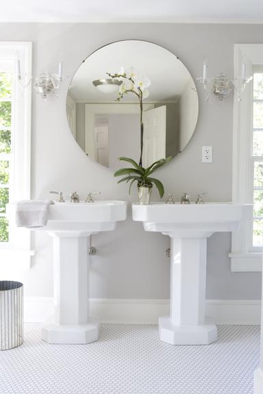 white master bathroom with twin pedestal sinks, round mirrors, and orchid flowers... Small Bathroom Ideas: Trendy Bathroom Mirror Updates from Bathroom Bliss by Rotator Rod