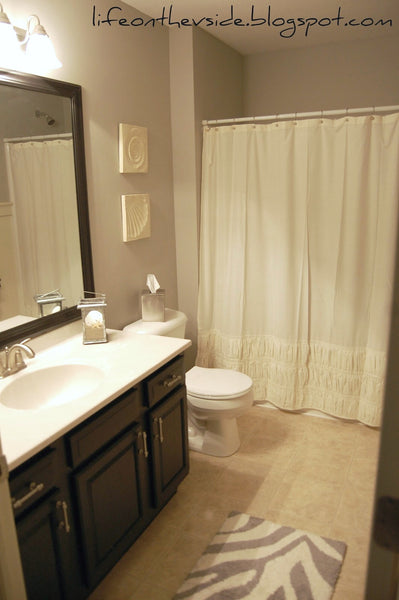 cute contemporary gray bathroom with white ruffle shower curtain, zebra bath rug, dark cabinets... Trending in Bathroom Decor: Airy, White Shower Curtains from Bathroom Bliss by Rotator Rod