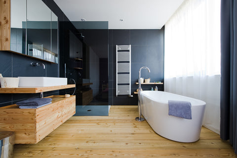 navy blue bathroom with light wood floor, modern and natural accents, free standing bathtub... Wood Floor Bathroom Inspiration from Bathroom Bliss by Rotator Rod 