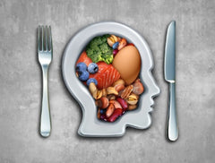 Knife and fork aside a head assorted with different foods representing a diet