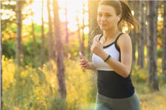 Female exercising as she jogs 