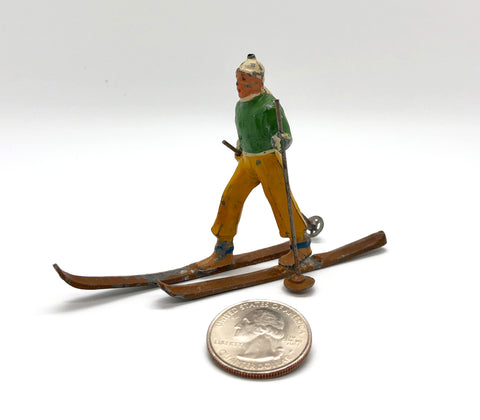 Vintage Toy Skier with quarter for scale