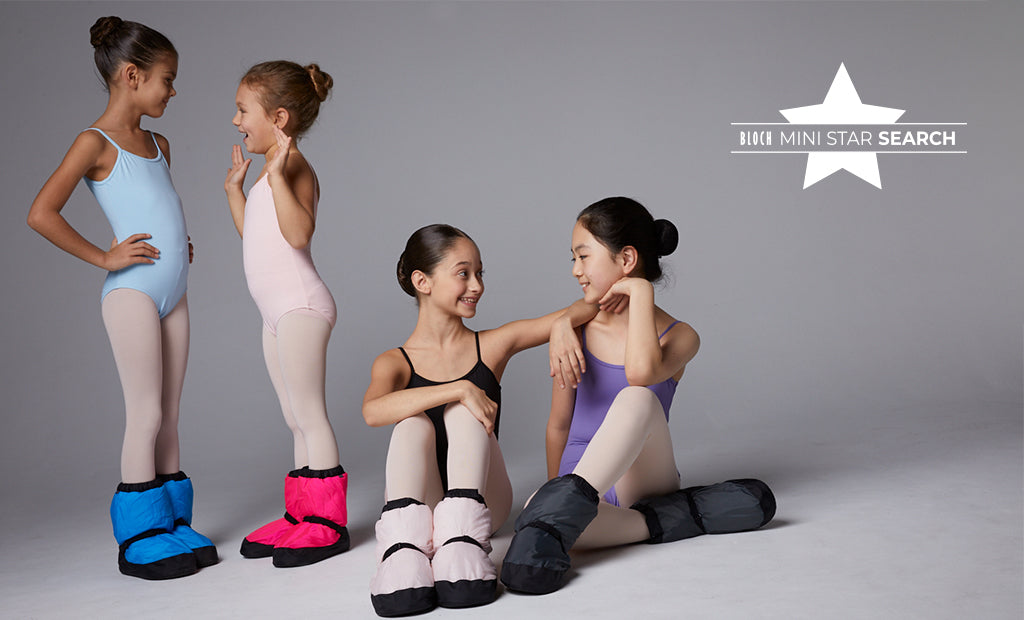 Four young ballet dancers chatting before ballet class, wearing BLOCH leotards, tights and Warm Up Booties
