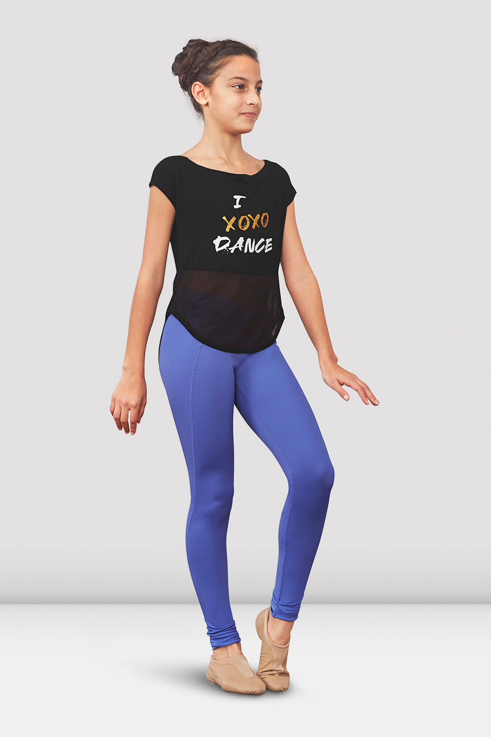 A young female ballet dancer wearing girls Renae tie back t-shirt with stirrup leggings in Iris