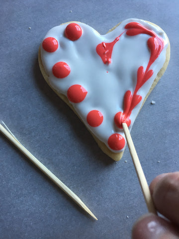 decorating heart sugar cookies with royal icing