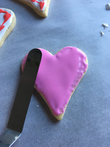 decorating heart sugar cookies with royal icing