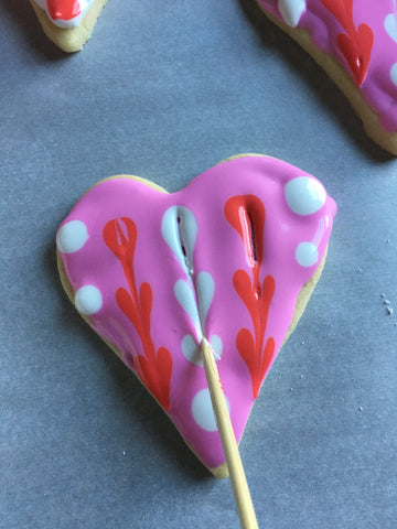 decorating heart sugar cookies with royal icing