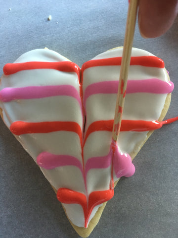 decorating heart sugar cookies with royal icing