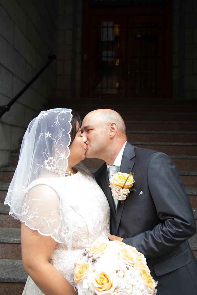 Maria Olaguera Forlini and Danny Forlini kiss at their intimate Filipino and Italian wedding in Montreal.