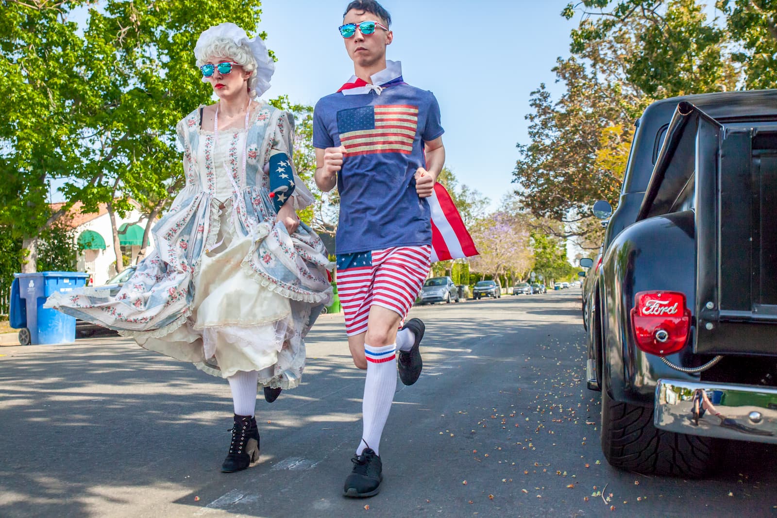 patriotic man and woman running in sunglasses