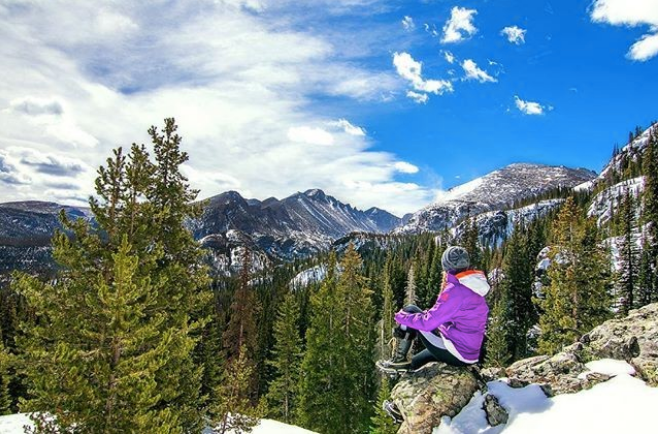 person sitting on rock at Rocky Mountain National Park