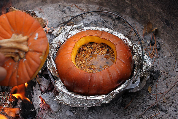 pumpkin in foiled pot sitting in campfire