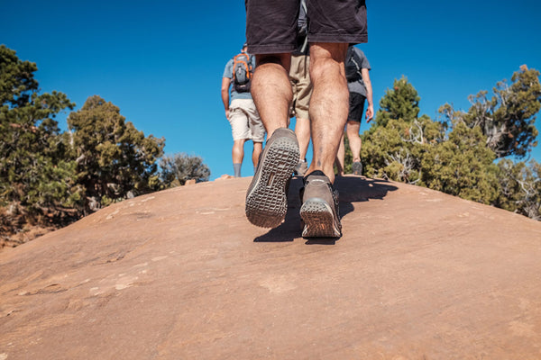 hikers walking up steep rock terrain