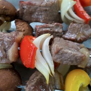Lamb kebabs with red peppers and onion.