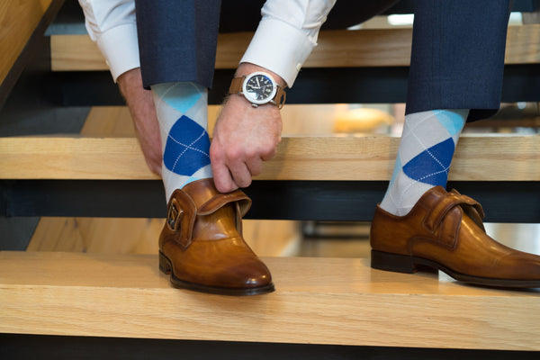 man wearing blue and grey argyle socks
