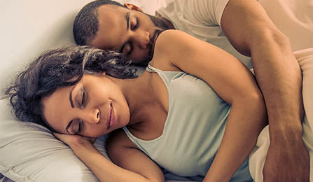 Mixed race couple cuddling and sleeping