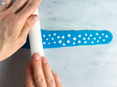Roll white dots on top of blue fondant to flatten them.