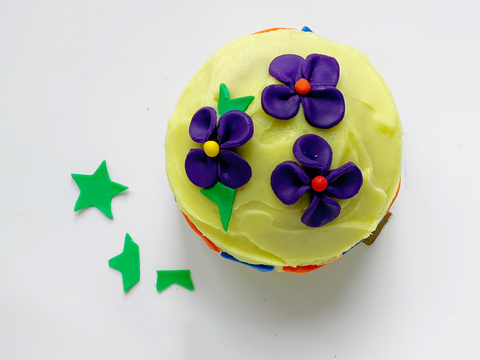 Fondant petals arranged on cake.