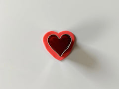 Cutting out fondant heart for cake decoration