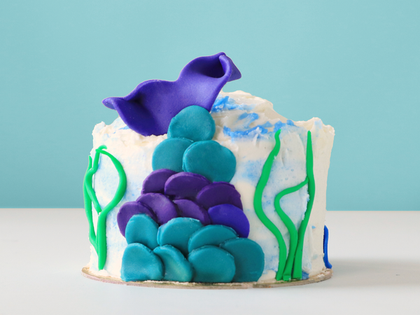 Mini cake with mermaid tail made from fondant.
