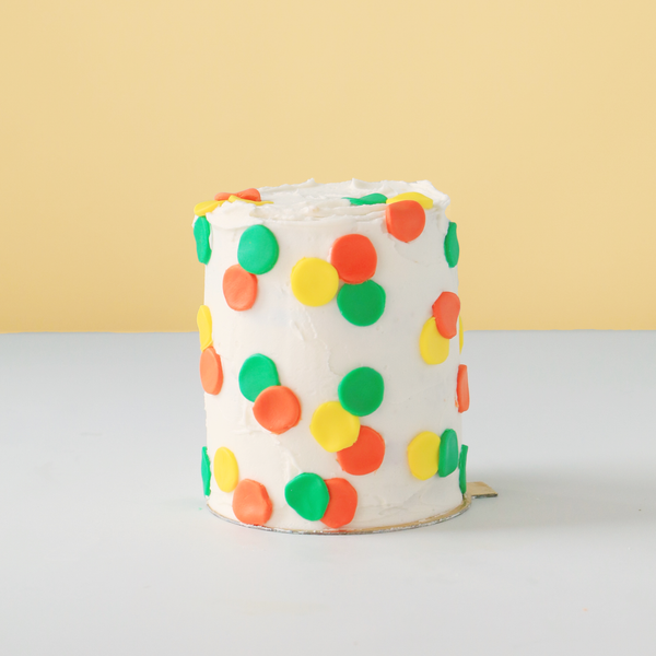 Tall mini cake with dots.