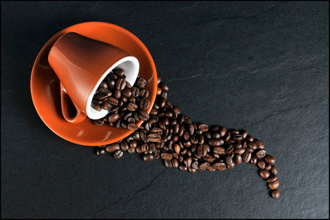 Coffee beans spilling out of mug, for Ivy Leaf Skincare blog