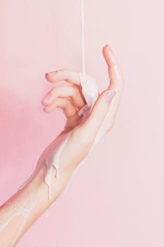 Person pouring lotion on hand, for Ivy Leaf Skincare blog