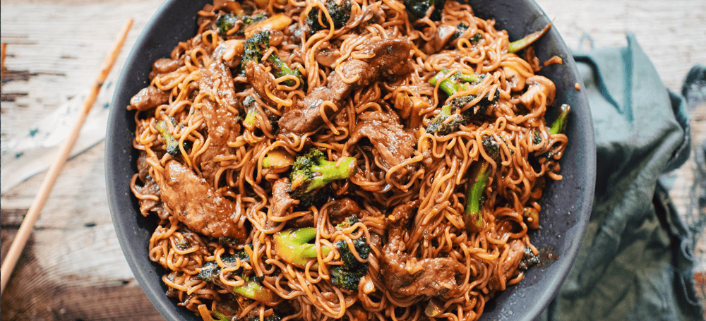 plate of noodles with beef and broccoli
