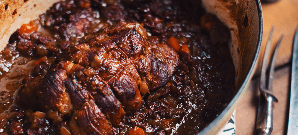 veal roast in pot with cranberry sauce