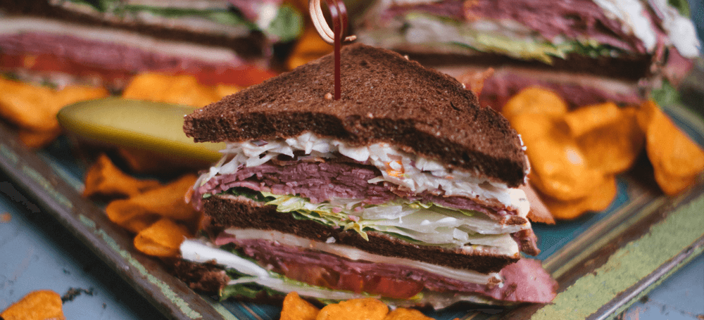 club sandwich in pumpernickel brown bread and smoked meat