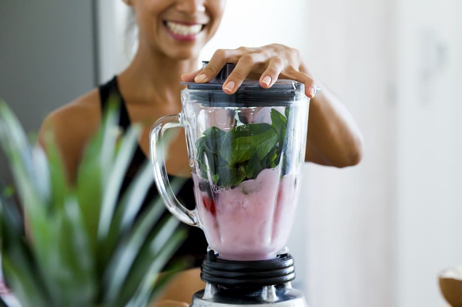 woman blending smoothie