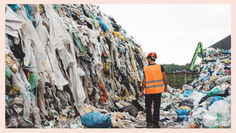 Image of a construction worker in front of a landfill of textile waste from fast fashion brands