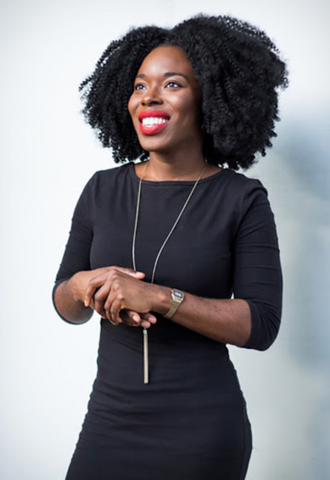 woman in sustainability in black dress smiling