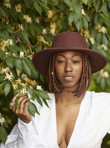 woman in sustainability posing with tree