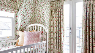 A perfect example of a Molly Mahon customer going full belt with our Strawberry hand block printed design with curtains and matching wallpaper in a London attic room