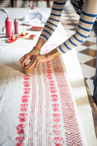 hand block printing a table runner for evening supper party with molly mahon
