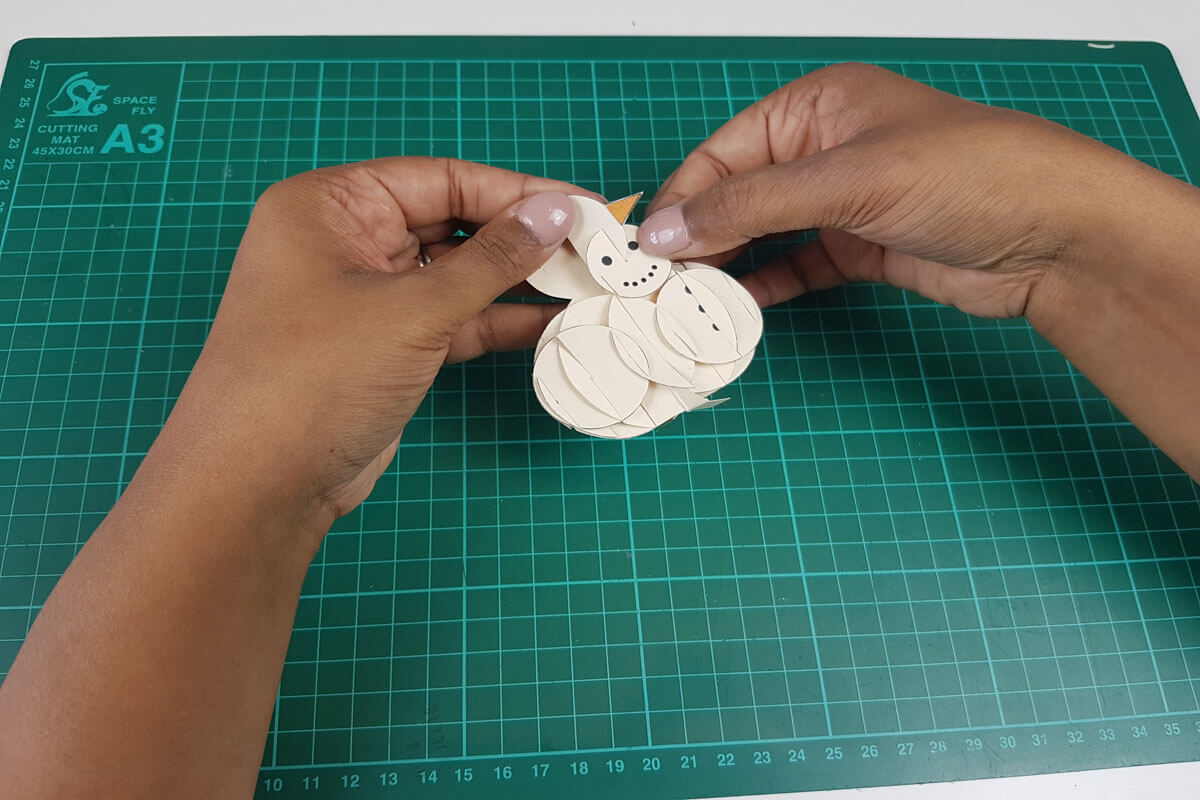 How To Make a 3D Christmas Pop Up Card - picture of putting the face of the snowman together