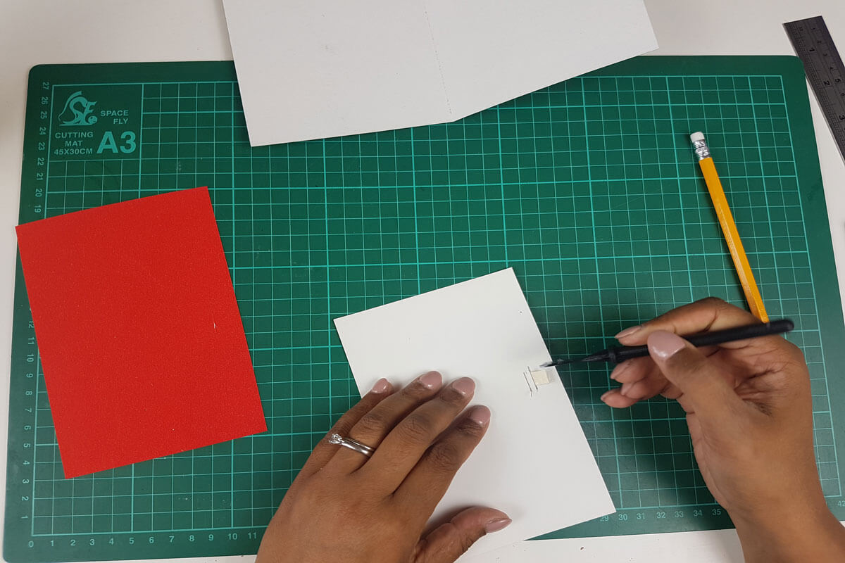 How To Make a 3D Christmas Pop Up Card - picture of gluing the tabs down to they down come apart