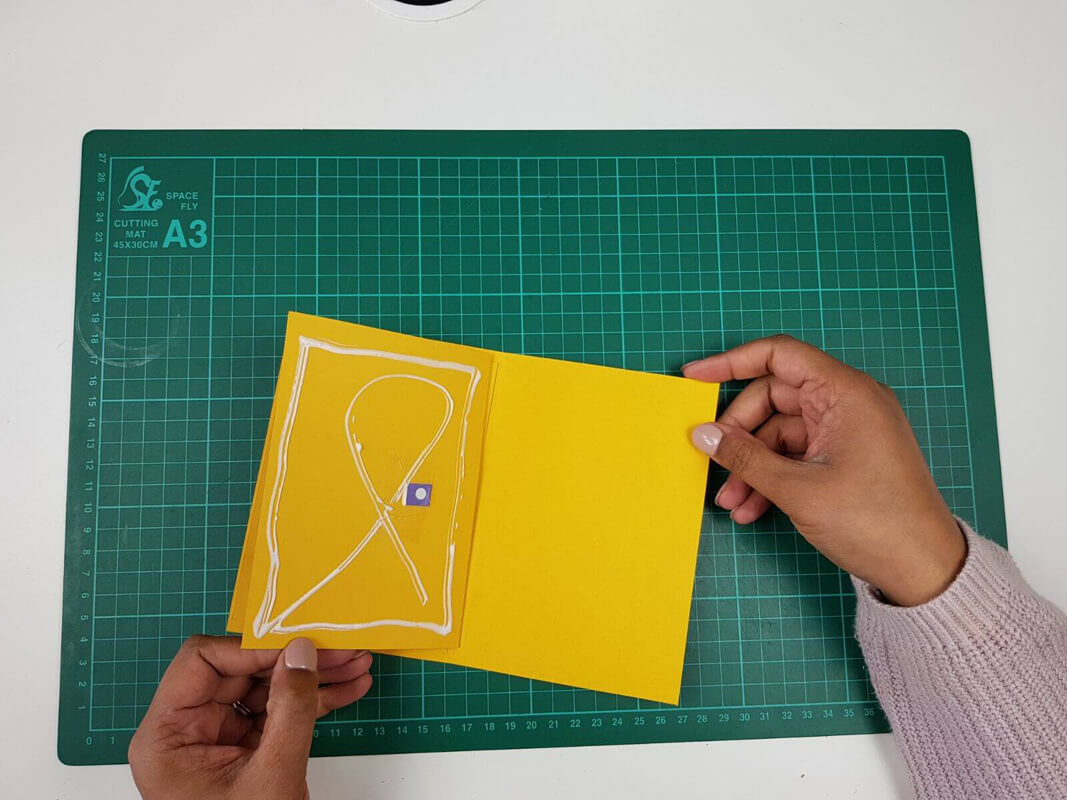How to make a birthday card pop up card tutorial - picture of gluing the inner card to the outer cardstock