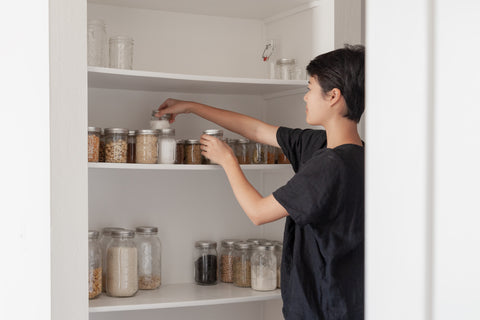 Woman reorganizing shelf products