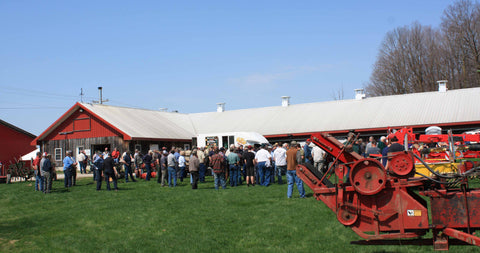 People gathering in front of the barn for the start of the auction.