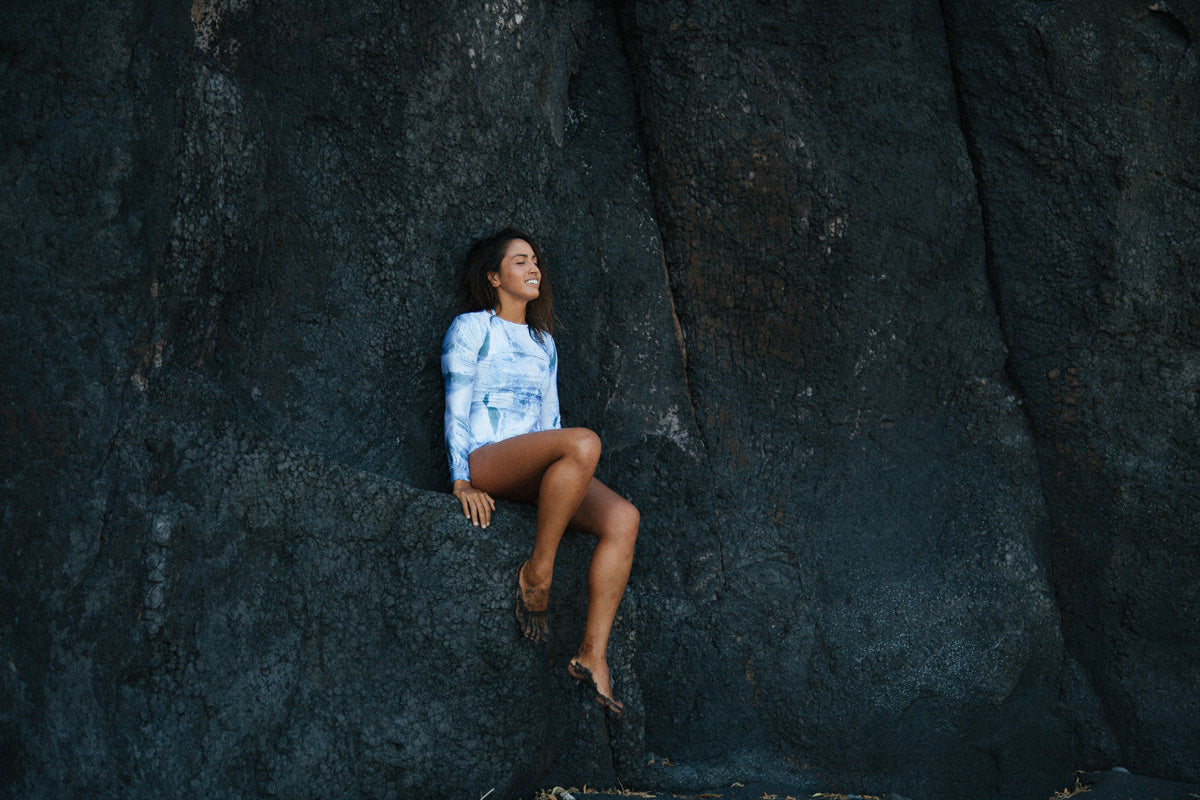 Mele Saili wears the Lynne rashguard on the black sand beaches in Maui. 