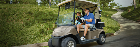 couple riding golf cart