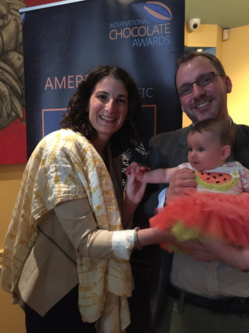 Family photo in front of awards banner